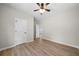 Bright bedroom with light-colored walls, wood flooring, and ceiling fan at 389 Campground School Rd, Dallas, GA 30157