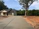 Long driveway leads to a new home featuring neutral siding and a welcoming covered entryway at 389 Campground School Rd, Dallas, GA 30157