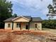 Newly constructed home with a covered porch and light-colored siding with wood shutters at 389 Campground School Rd, Dallas, GA 30157