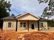 Newly constructed home with a covered porch and light-colored siding with wood shutters at 389 Campground School Rd, Dallas, GA 30157