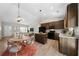 Open-concept living and dining area with a modern kitchen featuring an island and stainless steel appliances at 389 Campground School Rd, Dallas, GA 30157