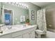 Well-lit bathroom featuring a double sink vanity and a shower/tub combo with decorative curtain at 4020 Emerald Glade Ct, Cumming, GA 30040