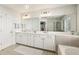 Bathroom featuring double sinks with a wide mirror, and white cabinetry at 4020 Emerald Glade Ct, Cumming, GA 30040