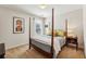 Cozy bedroom featuring a four-poster bed, soft carpet, and a bedside table with lamps at 4020 Emerald Glade Ct, Cumming, GA 30040