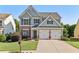 Charming two-story home with a well-manicured lawn and a two-car garage in a suburban neighborhood at 4020 Emerald Glade Ct, Cumming, GA 30040