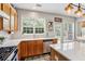 Bright kitchen with stainless appliances, wood cabinets, large windows, and breakfast bar at 4020 Emerald Glade Ct, Cumming, GA 30040