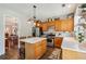 Bright kitchen showcases a center island, stainless steel appliances, and wooden cabinetry at 4020 Emerald Glade Ct, Cumming, GA 30040