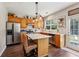 Cozy kitchen features stainless steel appliances, wooden cabinets, island, and a stylish pendant light at 4020 Emerald Glade Ct, Cumming, GA 30040