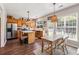 Cozy kitchen features stainless steel appliances, wooden cabinets, island, and a dining table at 4020 Emerald Glade Ct, Cumming, GA 30040