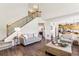 Open-concept living room featuring hardwood floors, stairs to the second floor, and an open floorplan at 4020 Emerald Glade Ct, Cumming, GA 30040