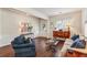Comfortable living room features hardwood floors, a sofa, an armchair, and ample natural light at 4020 Emerald Glade Ct, Cumming, GA 30040