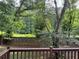 Wooded backyard seen from elevated deck with a wooden fence, offering privacy at 1035 Towne Manor Nw Ct, Kennesaw, GA 30144