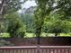 View of the fenced wooded backyard from the deck, featuring an expansive tree line at 1035 Towne Manor Nw Ct, Kennesaw, GA 30144