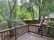 View of backyard with a wooden fence, seen from the elevated deck with brown railing at 1035 Towne Manor Nw Ct, Kennesaw, GA 30144