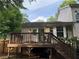Exterior of home with deck, stairs, and landscaped yard at 1035 Towne Manor Nw Ct, Kennesaw, GA 30144