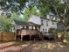 Exterior view of the two-story home with a wood deck and fenced yard at 1035 Towne Manor Nw Ct, Kennesaw, GA 30144