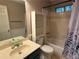 Bright bathroom featuring a toilet, vanity, and shower-tub combination with neutral tile at 1035 Towne Manor Nw Ct, Kennesaw, GA 30144