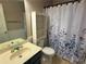 A full bathroom featuring floral shower curtain, and built in storage at 1035 Towne Manor Nw Ct, Kennesaw, GA 30144