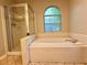 An ensuite bathroom featuring a walk-in shower and a garden tub at 1035 Towne Manor Nw Ct, Kennesaw, GA 30144