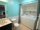 Bathroom with a toilet, vanity, and washer and dryer units at 1035 Towne Manor Nw Ct, Kennesaw, GA 30144