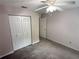 Bedroom with neutral walls, carpet flooring, closet, ceiling fan and white trim at 1035 Towne Manor Nw Ct, Kennesaw, GA 30144