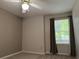 Bedroom featuring neutral walls, carpet flooring, and a window with wooded exterior views at 1035 Towne Manor Nw Ct, Kennesaw, GA 30144