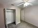 Bedroom with neutral walls, carpet flooring, closet, ceiling fan and white trim at 1035 Towne Manor Nw Ct, Kennesaw, GA 30144