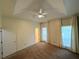 A spacious carpeted bedroom with ceiling fan and curtains on windows at 1035 Towne Manor Nw Ct, Kennesaw, GA 30144