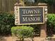 Welcome to Towne Manor, a community sign surrounded by lush landscaping at 1035 Towne Manor Nw Ct, Kennesaw, GA 30144
