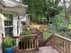 Elevated view of the wooden deck and surrounding wooded backyard with fence line at 1035 Towne Manor Nw Ct, Kennesaw, GA 30144