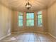 Dining area with tiled floor, large windows offering an outdoor view, and a decorative light fixture at 1035 Towne Manor Nw Ct, Kennesaw, GA 30144