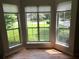 Bright room with hardwood floors, featuring a bay window offering beautiful outdoor views at 1035 Towne Manor Nw Ct, Kennesaw, GA 30144