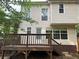 Back exterior of home featuring two stories with a wooden deck and stairs at 1035 Towne Manor Nw Ct, Kennesaw, GA 30144