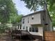 Exterior angle of the home with a deck and stairs to access backyard at 1035 Towne Manor Nw Ct, Kennesaw, GA 30144
