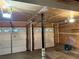 Three-car garage with white doors and overhead lights, offering ample parking at 1035 Towne Manor Nw Ct, Kennesaw, GA 30144