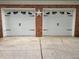 Close up on two garage doors set in brick, with a decorative metal star between them at 1035 Towne Manor Nw Ct, Kennesaw, GA 30144