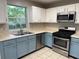 Bright kitchen featuring stainless steel appliances, ample countertop space, and a double sink under a window at 1035 Towne Manor Nw Ct, Kennesaw, GA 30144