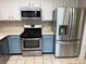 Kitchen featuring stainless steel appliances, including a microwave, range, and refrigerator at 1035 Towne Manor Nw Ct, Kennesaw, GA 30144