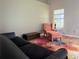 Comfortable living room with hardwood floors, a cozy armchair, and bright sunlight at 1035 Towne Manor Nw Ct, Kennesaw, GA 30144