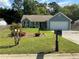 Charming single-story home featuring a well-manicured front yard with mature trees, flowerbeds and an attached two-car garage at 1109 Granite Ln, Loganville, GA 30052
