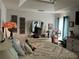 Comfortable main bedroom showcasing a tray ceiling, sitting area and a large mirror above the dresser at 1109 Granite Ln, Loganville, GA 30052