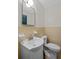 Traditional bathroom featuring a white sink, toilet, and tiled walls at 1729 Norden Rd, Riverdale, GA 30296