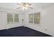 Simple bedroom featuring two windows bringing in plenty of natural light and a ceiling fan at 1729 Norden Rd, Riverdale, GA 30296