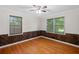 Bedroom with two windows and wood accent wall at 1729 Norden Rd, Riverdale, GA 30296