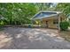 Side view of the house showing the long driveway, carport, and spacious backyard at 1729 Norden Rd, Riverdale, GA 30296