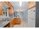 Bright kitchen with light wood cabinets, double sink, stainless steel dishwasher and a view to the dining area at 1729 Norden Rd, Riverdale, GA 30296