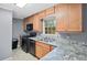 Kitchen with light wood cabinets, gray walls, double sink, and stainless steel appliances at 1729 Norden Rd, Riverdale, GA 30296