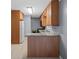 Compact kitchen features wood cabinets, laminate countertop, double sink, and modern appliances at 1729 Norden Rd, Riverdale, GA 30296