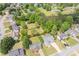 Aerial view of a neighborhood with mature trees and green lawns at 220 Chandler Ct, Sugar Hill, GA 30518