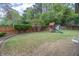 Landscaped backyard featuring a green lawn and a playset for  at 220 Chandler Ct, Sugar Hill, GA 30518